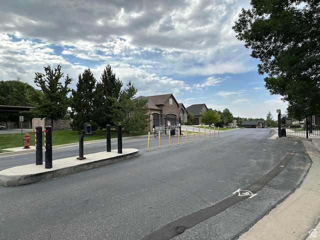 10227 Mystic Brook Way S, South Jordan, UT 84095 - view of asphalt road with a gated entry and curbs