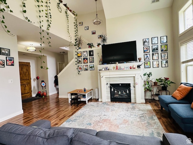 10227 Mystic Brook Way S, South Jordan, UT 84095 - living room with wood finished floors, a towering ceiling, a glass covered fireplace, and stairway