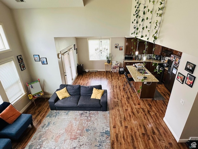 10227 Mystic Brook Way S, South Jordan, UT 84095 - living room featuring a chandelier, dark wood-style flooring, plenty of natural light, and a high ceiling