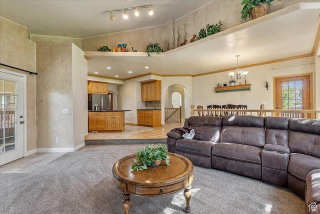2602 W 11625 S, Riverton, UT 84095 - living room featuring arched walkways, a chandelier, light tile patterned floors, light carpet, and ornamental molding