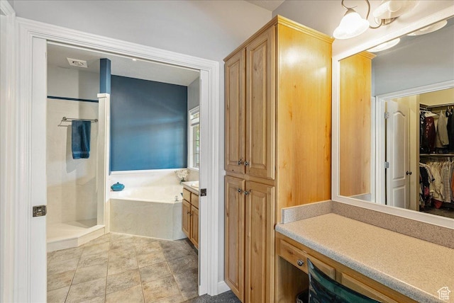 2602 W 11625 S, Riverton, UT 84095 - bathroom with vanity, a bath, a stall shower, and a walk in closet