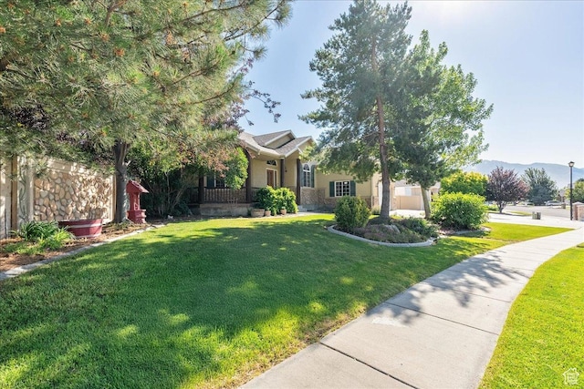 2602 W 11625 S, Riverton, UT 84095 - view of property hidden behind natural elements featuring a front yard, a mountain view, stucco siding, and stone siding