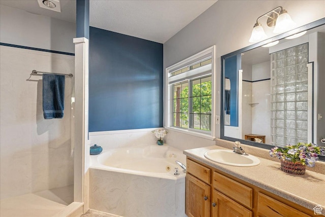 2602 W 11625 S, Riverton, UT 84095 - full bathroom featuring a walk in shower, a whirlpool tub, and vanity