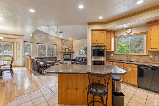 2602 W 11625 S, Riverton, UT 84095 - kitchen featuring dishwasher, double oven, a center island, light tile patterned flooring, and a breakfast bar