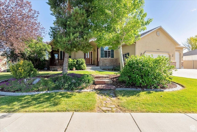 2602 W 11625 S, Riverton, UT 84095 - view of property hidden behind natural elements with an attached garage, a front lawn, stucco siding, and concrete driveway