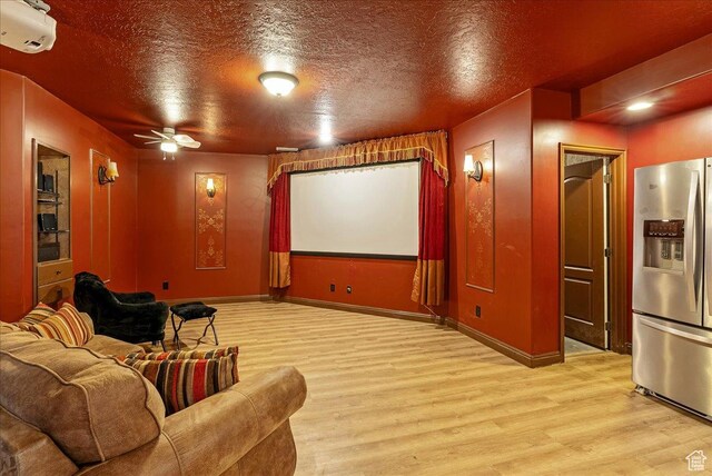2602 W 11625 S, Riverton, UT 84095 - cinema with wood finished floors, a ceiling fan, a textured ceiling, and a wall unit AC