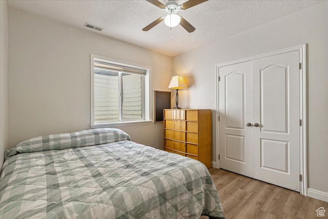 2602 W 11625 S, Riverton, UT 84095 - bedroom featuring wood finished floors, a textured ceiling, a closet, and a ceiling fan
