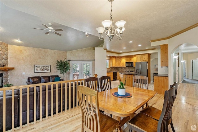 2602 W 11625 S, Riverton, UT 84095 - dining area featuring light wood-style flooring, a ceiling fan, arched walkways, a chandelier, and vaulted ceiling