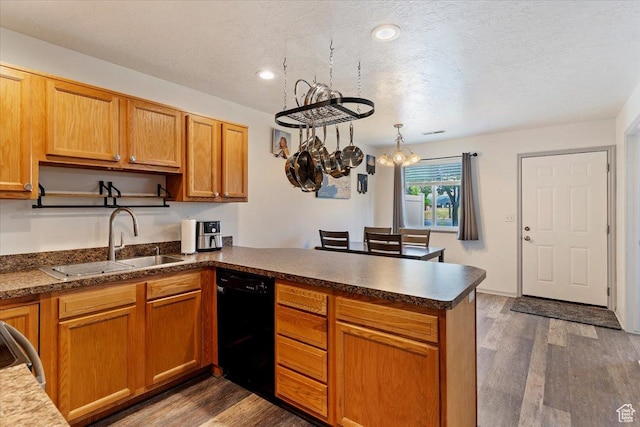 228 W 1975 N Unit 56, Harrisville, UT 84414 - kitchen with black dishwasher, a peninsula, a chandelier, dark wood finished floors, and range