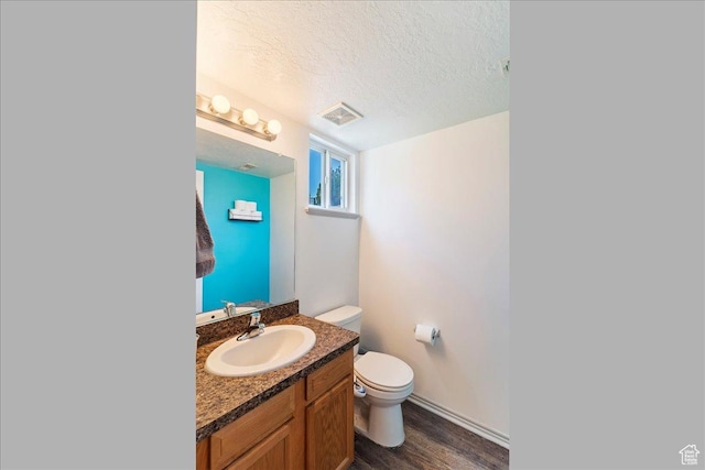 228 W 1975 N Unit 56, Harrisville, UT 84414 - half bath featuring vanity, a textured ceiling, and wood finished floors