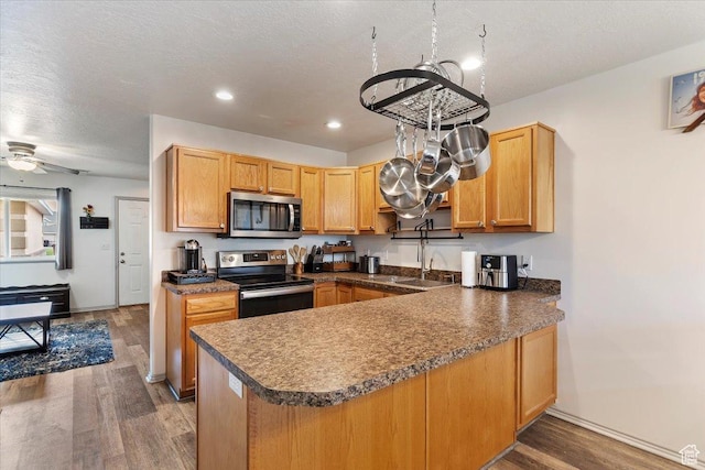 228 W 1975 N Unit 56, Harrisville, UT 84414 - kitchen featuring stainless steel appliances, a peninsula, light wood-style flooring, recessed lighting, and dark countertops