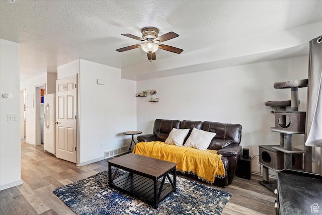 228 W 1975 N Unit 56, Harrisville, UT 84414 - living room with ceiling fan, light wood-style floors, and a textured ceiling