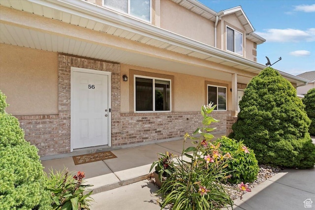 228 W 1975 N Unit 56, Harrisville, UT 84414 - entrance to property with stucco siding, a porch, and brick siding
