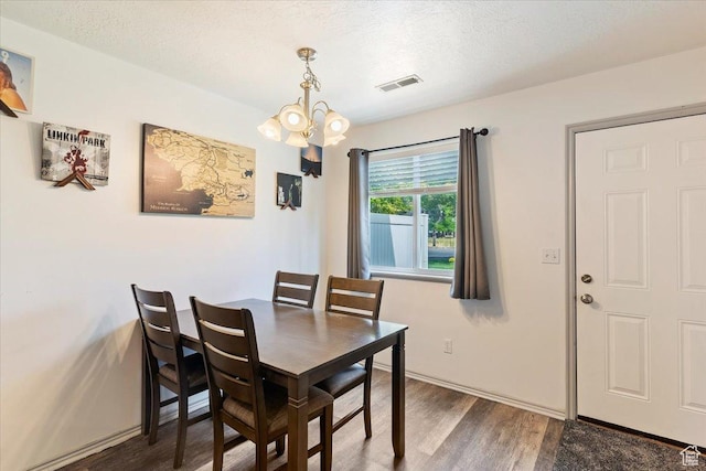 228 W 1975 N Unit 56, Harrisville, UT 84414 - dining area featuring a chandelier, wood finished floors, and a textured ceiling