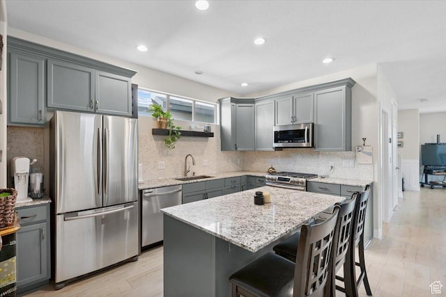 10848 S Tahoe Way S, Jordan, UT 84009 - kitchen featuring appliances with stainless steel finishes, gray cabinets, light stone counters, and recessed lighting