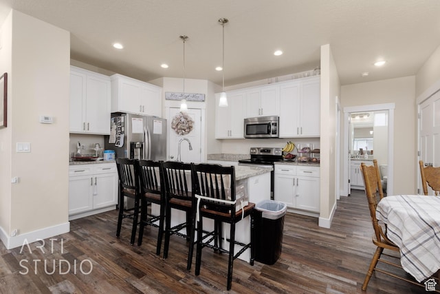 1619 N 1320 E, Payson, UT 84651 - kitchen featuring stainless steel appliances, dark wood-style flooring, a breakfast bar area, white cabinets, and recessed lighting