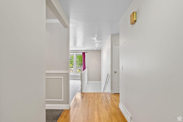 8711 S Rustler Rd, Cottonwood Heights, UT 84093 - corridor featuring light wood-type flooring and a textured ceiling