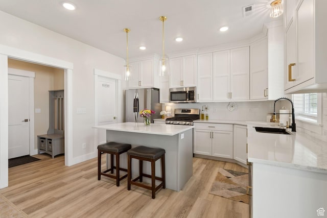 910 W 800 N, Tremonton, UT 84337 - kitchen featuring stainless steel appliances, light wood-type flooring, white cabinets, light countertops, and recessed lighting