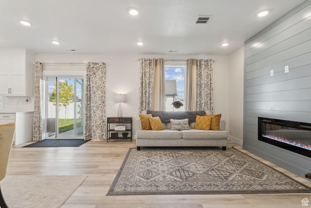 910 W 800 N, Tremonton, UT 84337 - living area with plenty of natural light, light wood-style flooring, a large fireplace, and recessed lighting
