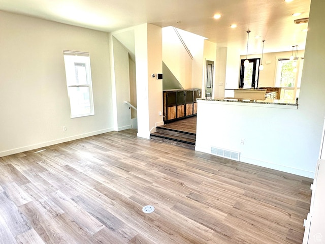 4843 W S Jordan Pkwy S, South Jordan, UT 84009 - unfurnished living room featuring wood finished floors and recessed lighting