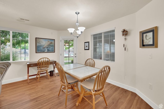 1225 W Dallin Dr Unit Q102, Pleasant Grove, UT 84062 - dining space featuring light wood-type flooring and a chandelier
