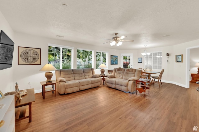 1225 W Dallin Dr Unit Q102, Pleasant Grove, UT 84062 - living room with light wood-style flooring, ceiling fan, a textured ceiling, and a chandelier