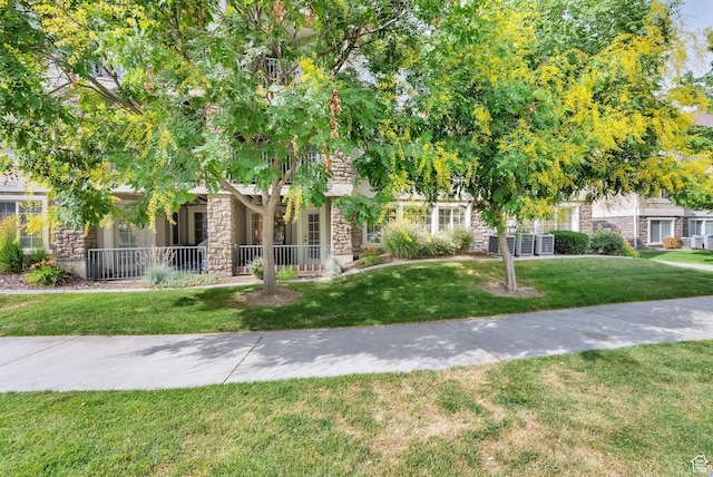 1225 W Dallin Dr Unit Q102, Pleasant Grove, UT 84062 - view of property hidden behind natural elements featuring stone siding and a front yard
