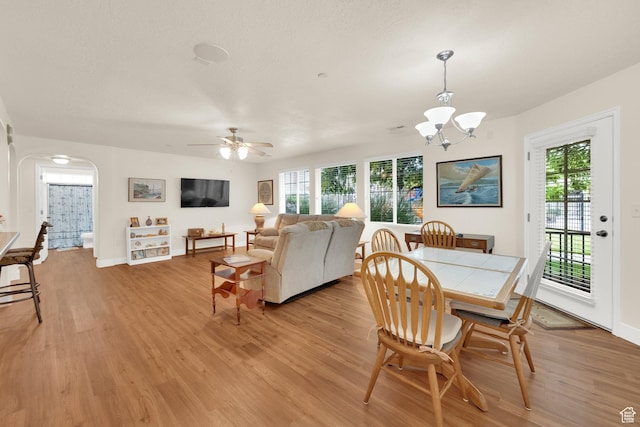 1225 W Dallin Dr Unit Q102, Pleasant Grove, UT 84062 - dining space with light wood finished floors, arched walkways, and healthy amount of natural light