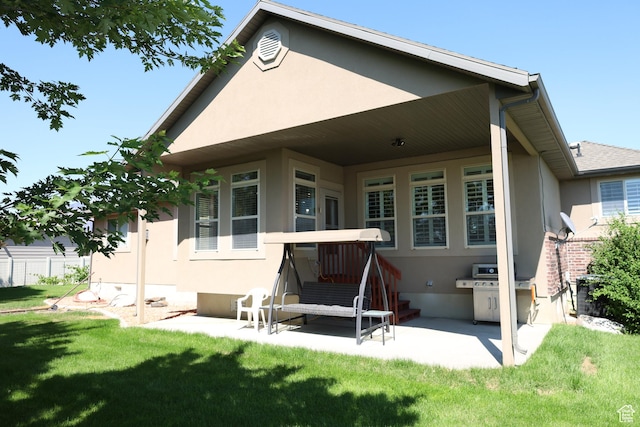 2681 N 3375 W, Plain City, UT 84404 - back of property with stucco siding, a yard, and a patio
