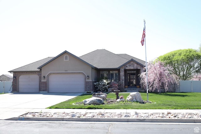 2681 N 3375 W, Plain City, UT 84404 - view of front of house with an attached garage, concrete driveway, brick siding, and a gate