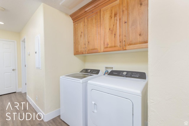 785 N Homestead St, Hildale, UT 84784 - laundry area featuring washer and dryer, light wood finished floors, cabinet space, and electric panel