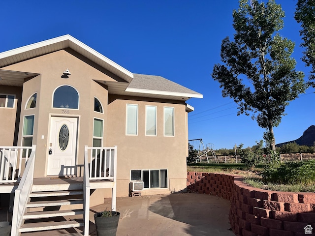 785 N Homestead St, Hildale, UT 84784 - doorway to property with stucco siding, a patio, and roof with shingles