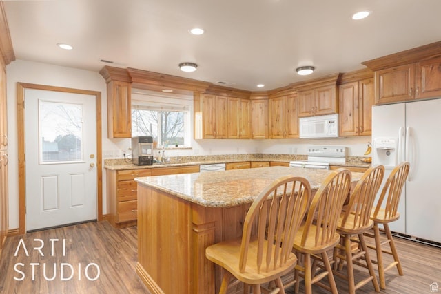 785 N Homestead St, Hildale, UT 84784 - kitchen with white appliances, a kitchen island, wood finished floors, a breakfast bar, and recessed lighting