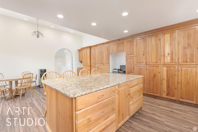785 N Homestead St, Hildale, UT 84784 - kitchen with arched walkways, wood finished floors, recessed lighting, a kitchen island, and light stone counters