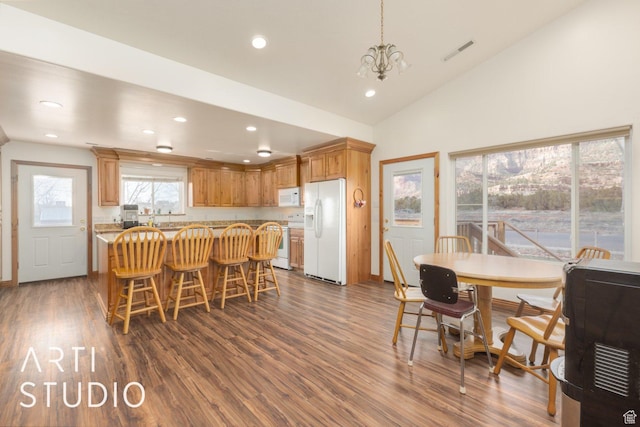 785 N Homestead St, Hildale, UT 84784 - kitchen with white appliances, dark wood-type flooring, recessed lighting, a kitchen bar, and a chandelier