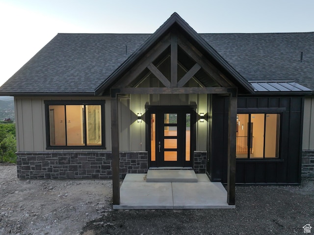 9281 E Rdg Pine Dr, Heber City, UT 84032 - entrance to property with board and batten siding, a shingled roof, and stone siding