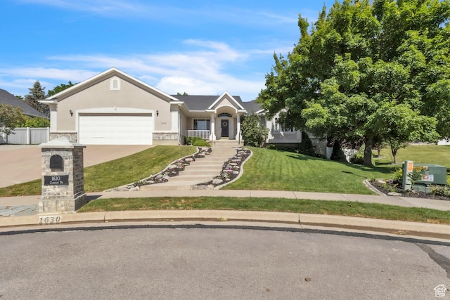 1630 N Camelot Dr E, North Logan, UT 84341 - ranch-style house featuring stucco siding, a garage, and driveway