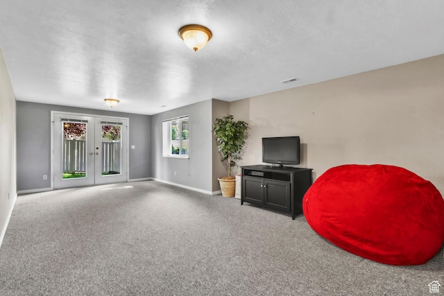 1630 N Camelot Dr E, North Logan, UT 84341 - carpeted living area featuring french doors and baseboards
