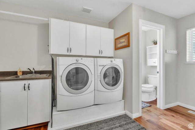 1630 N Camelot Dr E, North Logan, UT 84341 - laundry room featuring cabinet space, washing machine and clothes dryer, and light wood-style floors