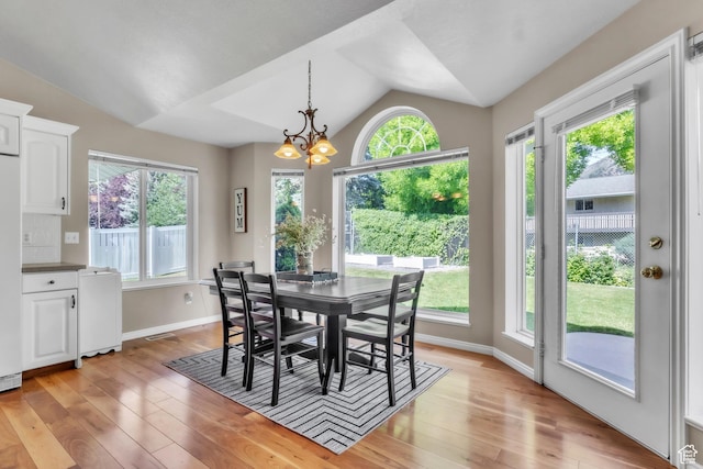 1630 N Camelot Dr E, North Logan, UT 84341 - dining area with vaulted ceiling, plenty of natural light, light wood-style flooring, and a chandelier