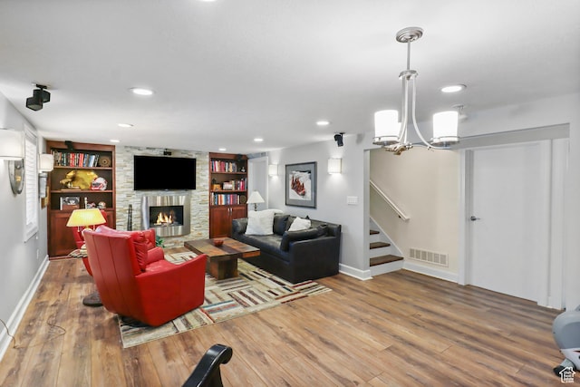 61 E 1700 S, Bountiful, UT 84010 - living room featuring wood finished floors, a fireplace, a chandelier, recessed lighting, and built in features