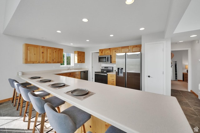 1719 Clyde Lake Dr Unit 346, Heber City, UT 84032 - kitchen featuring appliances with stainless steel finishes, recessed lighting, light countertops, a kitchen bar, and a peninsula