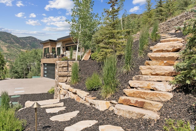 1400 Weber Wild Rd, Oakley, UT 84055 - view of home's exterior with an attached garage, a mountain view, a balcony, and driveway