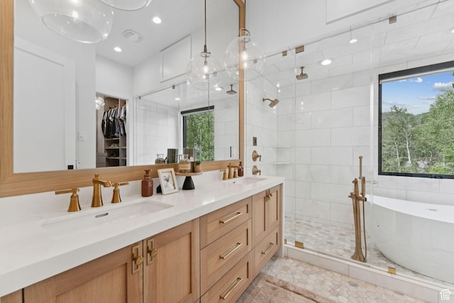 1400 Weber Wild Rd, Oakley, UT 84055 - bathroom with a shower stall, double vanity, a freestanding tub, a spacious closet, and recessed lighting