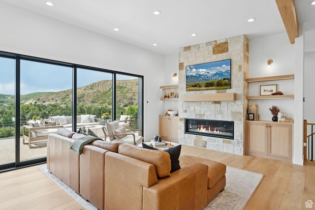 1400 Weber Wild Rd, Oakley, UT 84055 - living area featuring light wood-style floors, a stone fireplace, and recessed lighting