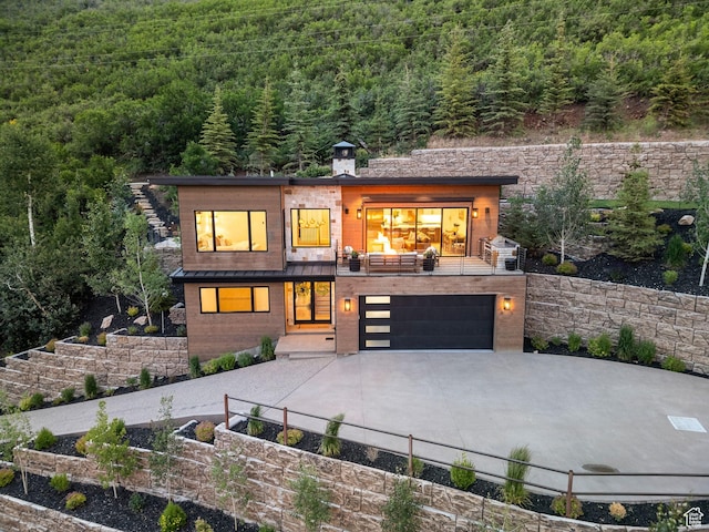 1400 Weber Wild Rd, Oakley, UT 84055 - modern home featuring a forest view, concrete driveway, and a garage
