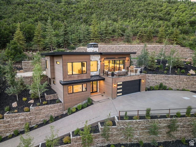 1400 Weber Wild Rd, Oakley, UT 84055 - contemporary home with a view of trees, concrete driveway, and a garage