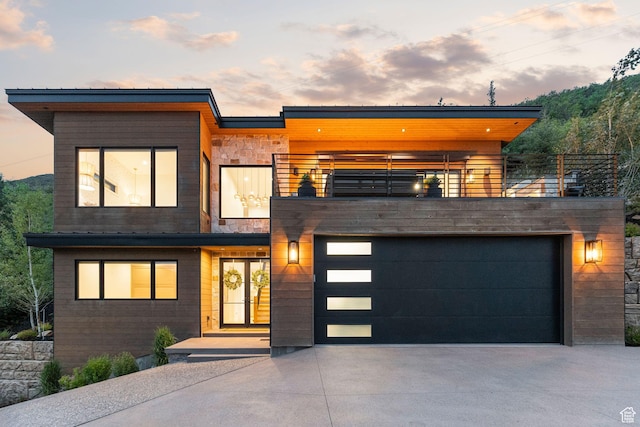 1400 Weber Wild Rd, Oakley, UT 84055 - modern home with a balcony, concrete driveway, and a garage