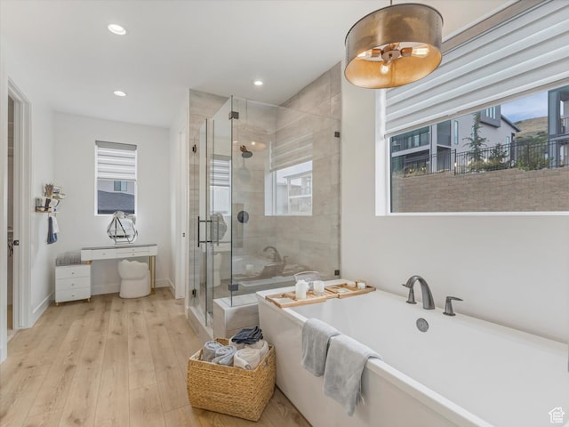 5796 N Valley View Rd, Lehi, UT 84043 - full bathroom featuring a freestanding tub, a stall shower, wood finished floors, and recessed lighting