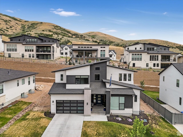 5796 N Valley View Rd, Lehi, UT 84043 - modern home with a mountain view, driveway, an attached garage, a residential view, and stucco siding